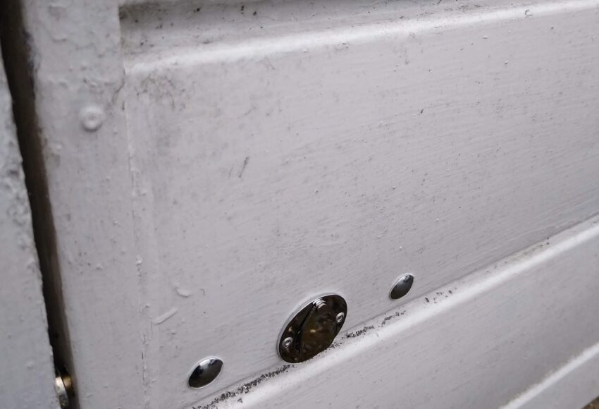 Key operated concealed security bolt on garage door