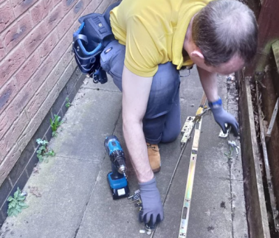 CraftLock locksmith at work in a garden in Birmingham CraftLock locksmith at work on garden fence lock in Birmingham